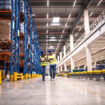 distribution-warehouse-interior-with-workers-wearing-hardhats-reflective-jackets-walking-storage-area.jpg